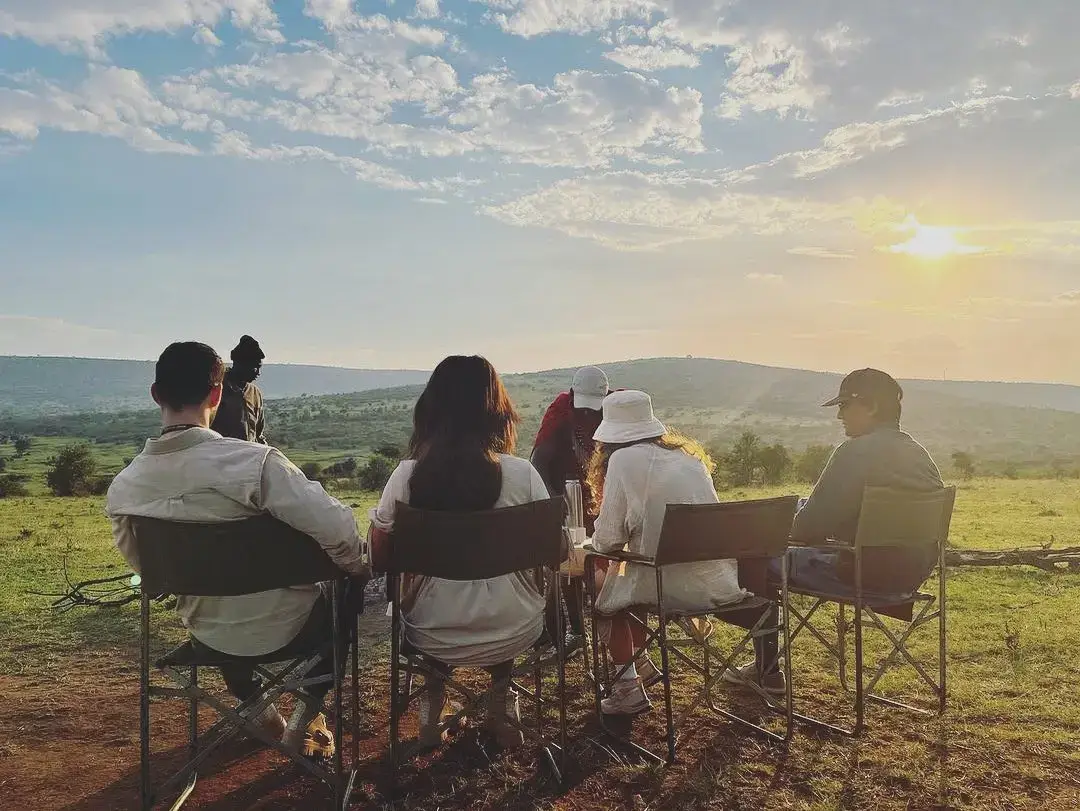 Family on a safari at Masai Mara National Reserve enjoying quiet time