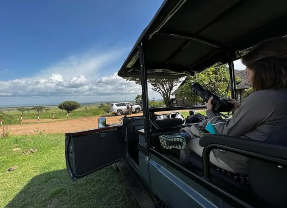 tourist in open sided safari jeep kenya