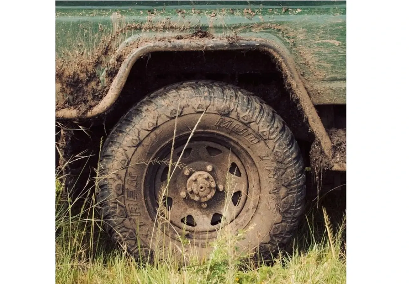 Tourist vehicle with mud during rainy season at Masai Mara National Reserve