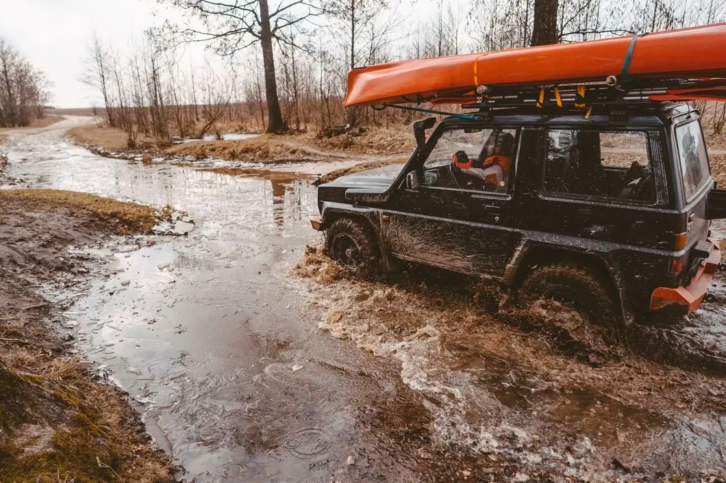 Tourist vehicle stuck during rainy season at masai mara